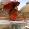 A Boy with a Red Umbrella poses in front of the Mosque at Lodhi Garden. - Image 2